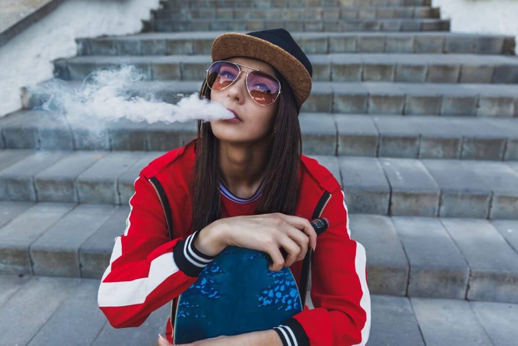 young woman with skateboard vape e cig 2023 11 27 04 56 51 utc Neon City Smoke Shop